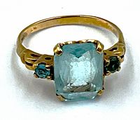 Front view showing rectangular aquamarine and flanking green stones on yellow gold band