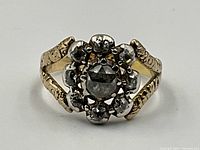 Top-down view showing central rose-cut diamond and surrounding eight diamonds in cluster setting