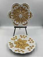 Front view of both plates, one on stand and one flat