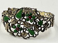 Front view showing carved jade teardrop and round stones set in floral filigree silver