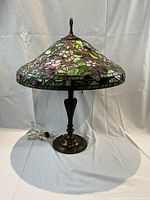 Full frontal view of lamp showing stained glass shade and metal base
