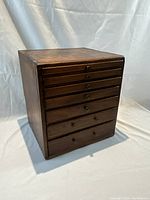 Front view of wooden chest with all seven drawers closed