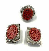 Ring and earrings displayed on white background