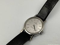 Close-up of watch dial and stainless steel case