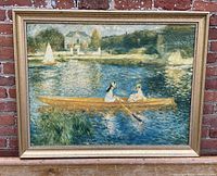 Full front view of the framed painting leaning against a brick wall