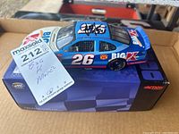 Autographed Jimmy Spencer Big Kmart #26 model car displayed on original box with MaxSold lot tag visible.