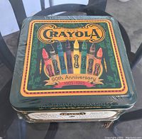 Top view of the Crayola 90th Anniversary tin with colorful crayon artwork and text 90th Anniversary 1903-1993