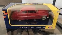 Front and side view of the Motor Max 1949 Mercury die-cast model car in original box with clear display window.