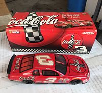 Die-cast model car with original box, showing top and left side with Coca-Cola graphics and #3.