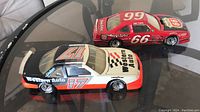 Top view showing the #66 red Phillips 66 car and the #17 Western Auto black, white, and red car side by side.