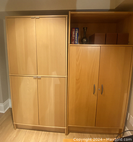 Photo of two Ikea office cabinets side by side. Left cabinet has four doors with silver square handles, light wood finish. Right cabinet has two doors with curved silver handles, medium wood finish and items on top.