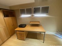 Ikea office furniture set including desk, 3-drawer mobile cabinet under desk, freestanding cabinet, and printer on desk (not included)