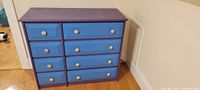 Front view of painted 8 drawer dresser showing the color and style of drawers and knobs.