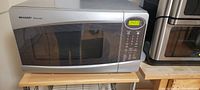 Silver Sharp Carousel microwave oven showing control panel and door closed
