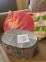 Photo shows metal utensil caddy with floral print and three compartments alongside large reusable tote bag with pink pineapples and green stripes.