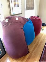 Three bean bag chairs grouped together front view