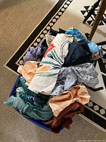 Top-down view of the fabric tote showing a variety of colorful fabrics including floral prints, solid colors, and other patterns.