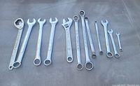 Photo showing 12 assorted metal wrenches including an adjustable wrench.