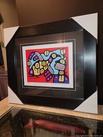 Frontal view of the framed art print showing the vibrant colors and Christian Morrisseau's signature style with corner protectors on the frame.