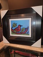 Front view of the framed fine art print showing the artwork and protective corner covers on the frame