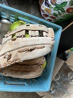 Baseball glove showing model DG-1000DX made in Japan in top view, displaying leather and stitching condition