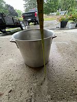 Large metal corn pot measured for depth, showing approximately 20 inches deep.