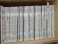 Shelf filled with dozens of woodworking magazines, mostly white spines with black text.