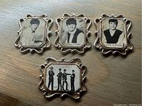 Set of four vintage Beatles charms showing Paul McCartney, Ringo Starr, John Lennon, and a group photo with ornate metal frames.