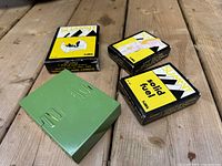 Green metal pocket stove and three boxes of Summit solid fuel cartridges on a wooden surface