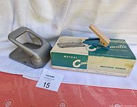 Photo showing the Mutual Centamatic multiple hole punch with original box, two-hole punch, and small single hole punch together.