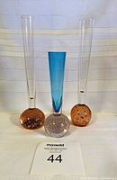 Full view of three bud vases showing configuration and colors