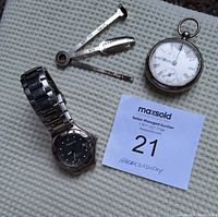 Full lot overview showing pipe tool, two watches (Orleans pocket watch and Citizen wristwatch), and match holder.