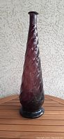 Full front view of tall amethyst Empoli glass genie bottle showing flared lip, spiral pattern, and wide base