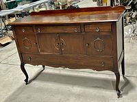 Solid walnut wood buffet by Krug Bros. & Co., closed front with drawers and cabinet doors, decorative metal pulls, cabriole legs.