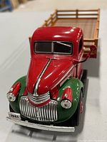 Front view of the 1941 Chevrolet diecast truck model showing red and green paint, chrome grille, and license plate.