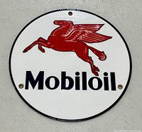 Front view of round Mobiloil porcelain sign showing flying red Pegasus and black text.