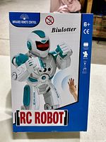 Front of box showing white and teal RC Robot with infrared remote control and kid age recommendation 6+. Biulotter brand visible.