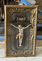 Front view of the vintage framed crucifix display box showing ornate frame, crucifix, and glass front.