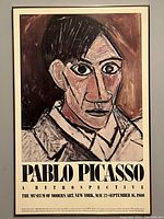 Full view of framed exhibition poster featuring cubist portrait of Pablo Picasso