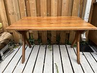Full view of vintage solid wood desk showing rectangular top and double-leg base.