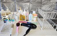 Overall view of all bathroom products, hair appliances, wire rack and bin