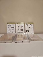 Front view of all three stamp sets in cases with blocks stacked in front