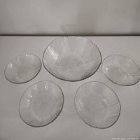 Top view of large salad bowl and four small bowls showing full set