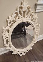 Full view of ivory ornate oval mirror front