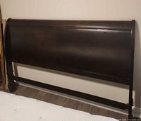 Full front view of dark wood king sleigh headboard
