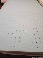 Perforated light blue gel memory foam surface of topper