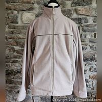 Front view of cream fleece jacket on mannequin, zip pockets visible