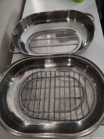 Two-piece stainless steel roaster shown with wire rack inside deeper pan