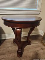 Full view of the round side table showing overall design and leg structure