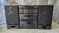 Front view of complete Sanyo stereo system with two speakers attached
